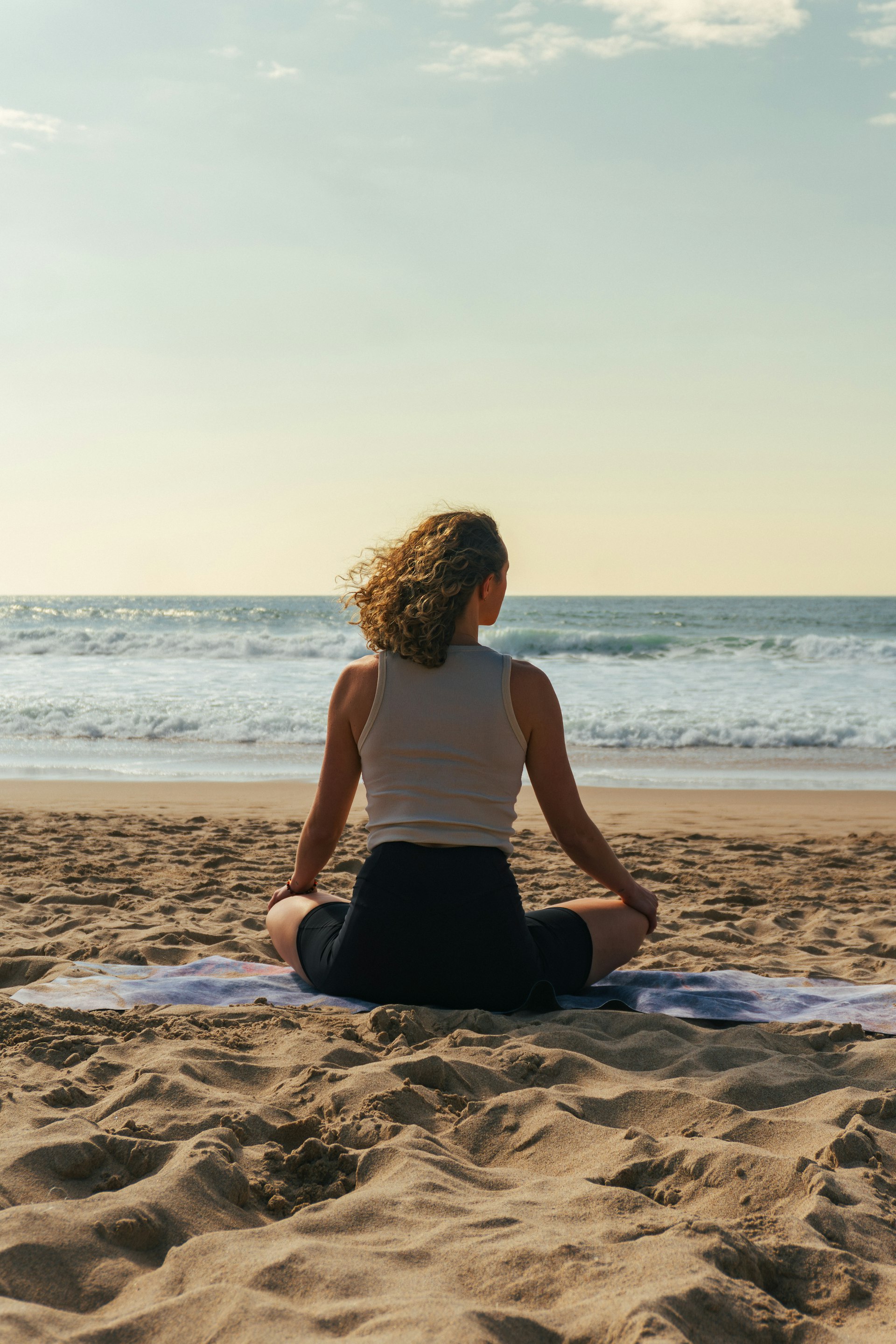 Woman meditating by the ocean
